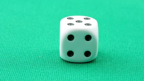 White die on green table stop motion Stock Footage 76715510