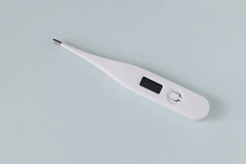 White digital thermometer on a gray background Stock Photos