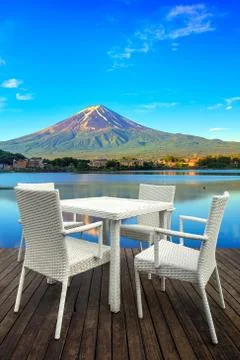 White dining table on lake and mountain background Stock Photos