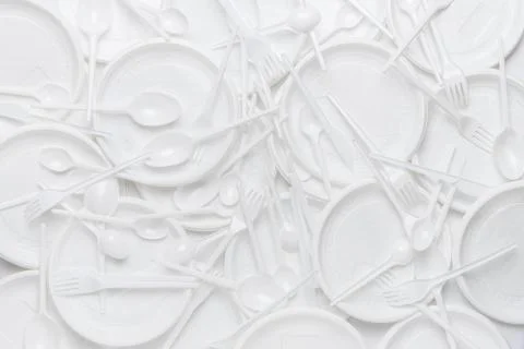 White disposable plastic tableware. Plastic plates, forks, spoons, knives. Ab Stock Photos