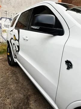 White Dodge Durango SRT Hellcat with graphic decal and urban graffiti backd.. Photos