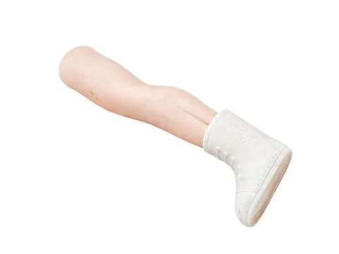 White Doll Leg with Small Boot on Plain Background 스톡 사진