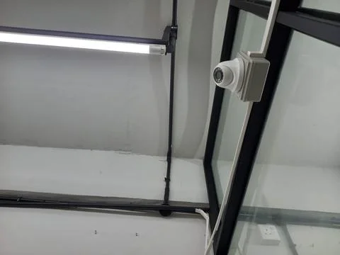 White dome CCTV camera installed on office wall. Image office 38 of 60. Stock Photos