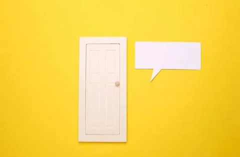 White door and speech bubble on yellow background Stock Photos