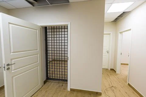 The white door with grid that is as prison cell. Concept of house arrest. Stock Photos