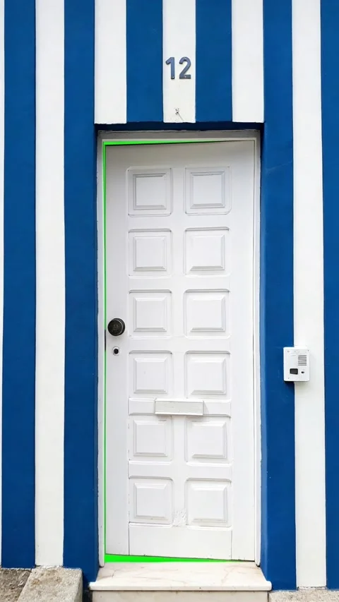 White door in striped wall opening revealing green screen background, chroma key Stock Footage 331135355