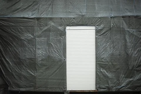 White door in wall. Back Exit. Blinds on door. Stock Photos