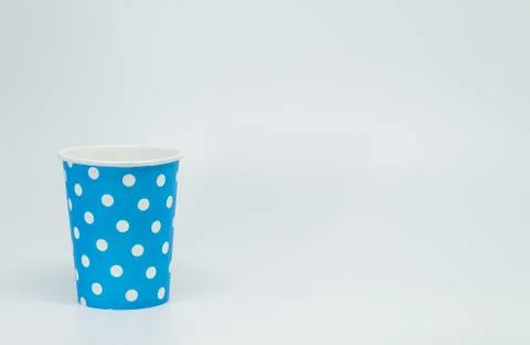 White dot pattern on Blue paper cup with white background and selective focus Stock Photos