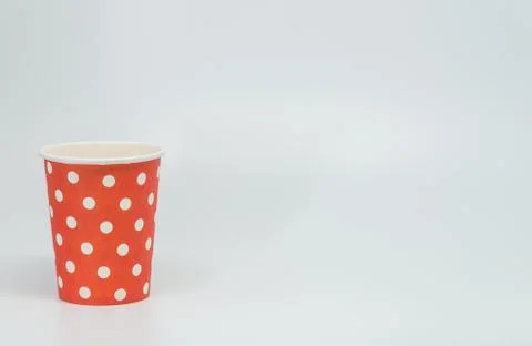 White dot pattern on red paper cup with white background and selective focus Stock Photos