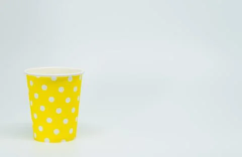 White dot pattern on Yellow paper cup with white background Stock Photos