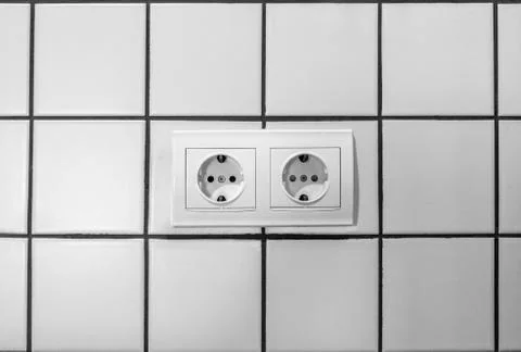 White double electrical outlet mounted on white wall Stock Photos