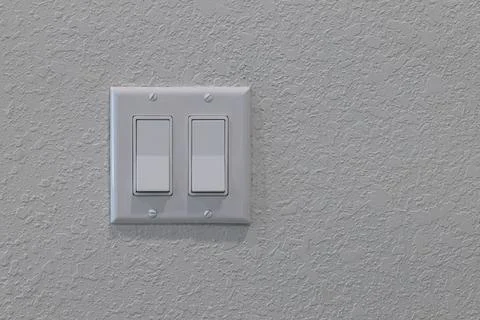 White double light switch mounted on textured wall with four visible screws Stock Photos