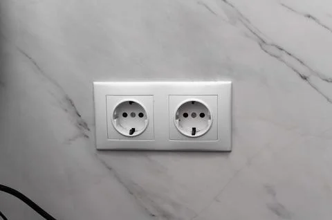 White double socket mounted on tiled bathroom wall. connection and modern h.. Stock Photos
