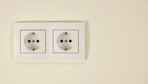 White double socket on the wall. The concept of electricity supply in the house. Stock Photos
