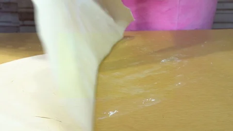 White dough raise from the table and placed on a black dish Stock-Footage 127082268