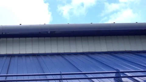 White downpipe on the background of blue wall Stock Footage 75914811