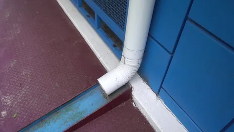 White downpipe on the background of blue wall Stock Footage 75915185