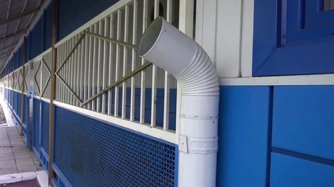 White downpipe on the background of blue wall Stock Footage 75915302