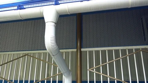 White downpipe on the background of blue wall Stock Footage 75915371