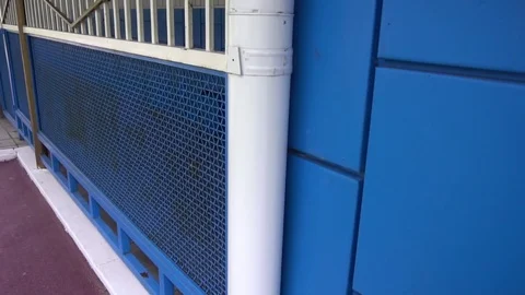 White downpipe on the background of blue wall Stock Footage 75915393