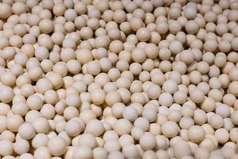 White dragee candy balls arranged as a clean sweet background texture. Stock Photos