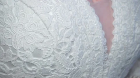 White dress of the bride. Camera movement from top to bottom. Close up. Lace Stock Footage 238021587