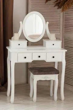 White dressing table with oval mirror and chair is part of cosy interior of.. Stock Photos