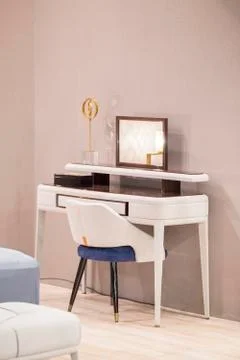 White dressing table with wicker elements, leather upholstery, luxury mirror. Stock Photos