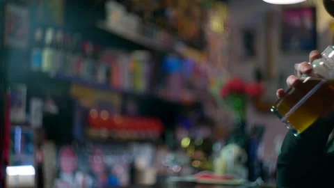 White an drinking beer in the bar in slow motion Stock Footage 220623004