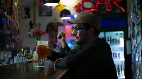 White an drinking beer in the bar in slow motion Stock Footage 220623124