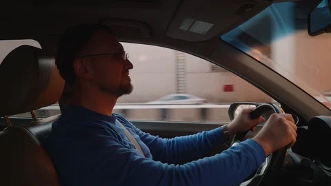 White driver drives in and out under pass in car. Comfortable place. Smartphone Stock Footage 109330550