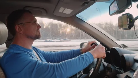White driver uses smartphone navigator driving on highway to check road. Way Stock Footage 109417861