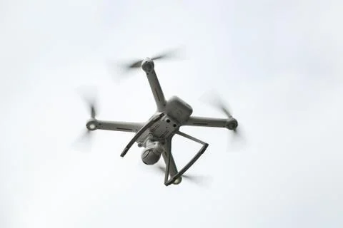 White drone on the background of sky. Closeup. Stock Photos