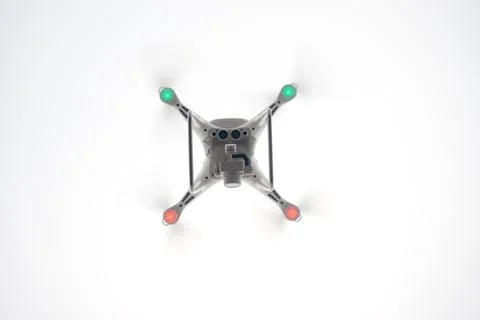 White Drone with Camera Flying in Blue Sky. UAV Concept Стоковые фото
