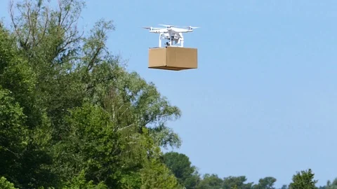 White Drone delivers  cargo  box in rural area .Close up, Slow motion Video stock 91351982
