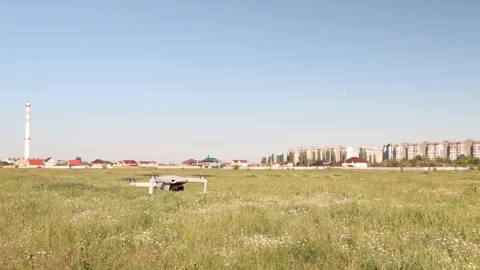 White drone with a digital camera flies against the background of the city 스톡 동영상 165927045