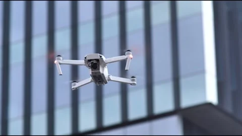 White Drone Hovering Near Modern Glass Building Exterior Stock Footage 342977665