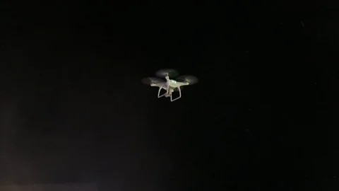 White drone shoots video on the background of the night sky. 動画素材 114228499