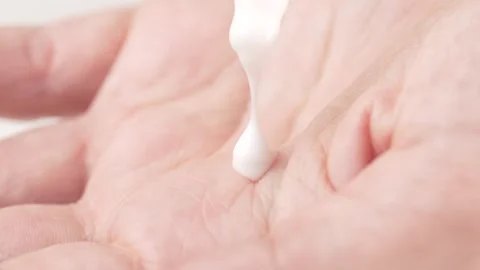 White drop of serum falling from the pipette on the dry skin. Lotion in the.. Stock Footage 302919087