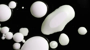 White drops of paint on a black background Stock Footage 85911462