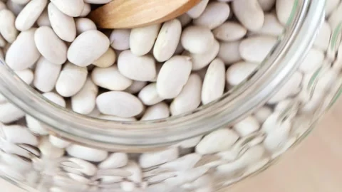 White dry beans rotate on a turntable Stock Footage 247318935