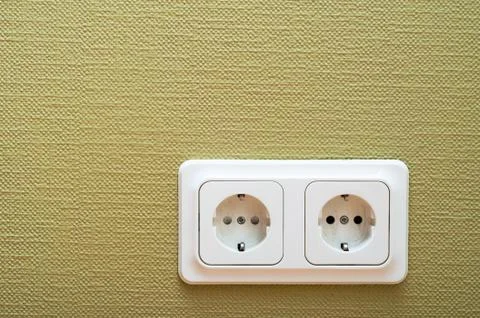 White dual socket on green wall Stock Photos
