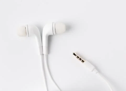 White earbuds with socket isolated on  background Stock Photos