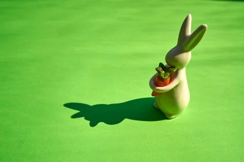 White easter bunny on green paper background Stock Photos