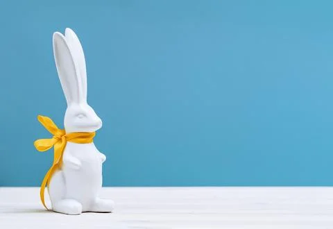 White Easter bunny on white table on blue Stock Photos