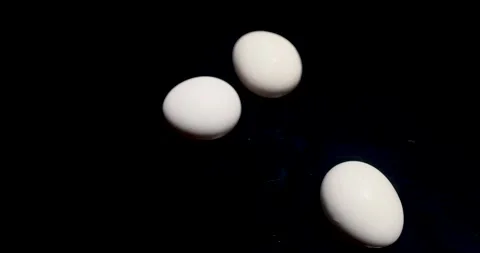 White Easter chicken eggs spin on a black table. Perfect for Easter, 動画素材 287806798