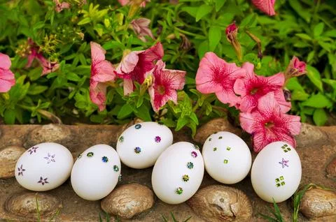 White Easter Egg Arrangement with Flowers and Greenery Stock Photos