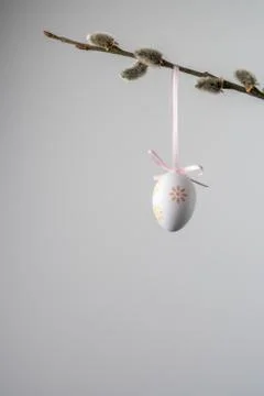 White easter egg hanging from a willow twig with catkins Stock Photos