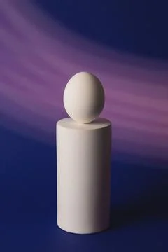 White easter egg on podium in neon and purple light Stock Photos