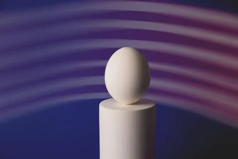 White easter egg on podium in neon and purple light Stock Photos